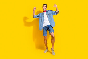 Full body photo of optimistic man dressed denim shirt indicating at himself near empty space isolated on vivid yellow color background