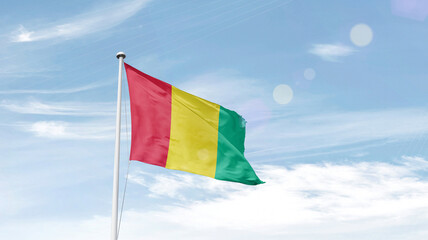 Guinea national flag cloth fabric waving on the sky - Image