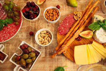 Dinner with snacks and wineglasses on table in living room