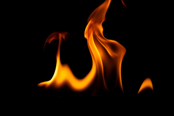 Fototapeta premium Hot flames on a black background. Beautiful flame of fire in the dark. Abstract of burning flames and smoke.