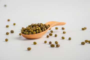 Mung beans isolated on spoon wooden on white background