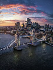 Aerial sunset view of the famous Tower Bridge in London and the skyscrapers of the city in the...