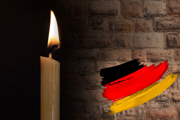 mourning candle burning front of flag Germany, Victims of cataclysm or war concept, memory of...