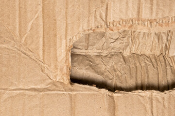 Damaged cardboard box with a hole