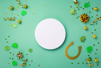Golden Horseshoe, Gold Coins and Clover Leaves Shamrocks on Green Background for St Patricks Day...