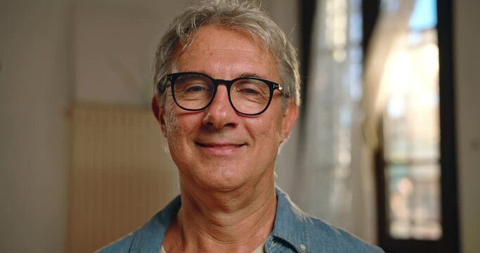 Portrait of a middle-aged man at home.
The man looks into the camera and smiles happily.