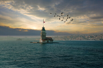 Fototapeta na wymiar Maiden's Tower at Dawn, Birds in Flight, Istanbul Bosphorus Seascape, Tranquil Turkish Landmark.