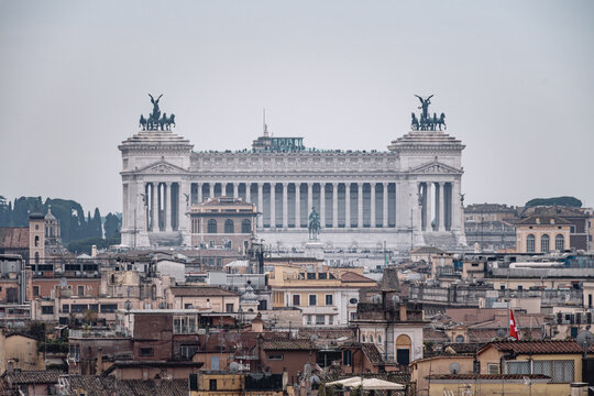 view of the rooftops of rome and the Vittoriano on a gray winter day