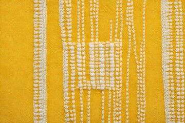 Embroidery design by yellow and white cotton threads on flax. B