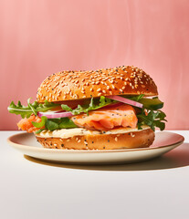 bagel sandwich with salmon on the pink background