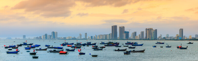 Naklejka premium Fishing boats at My Khe beach with sunrise in Danang , Vietnam, Bamboo basket boat, Local fishing boats in Vietnam