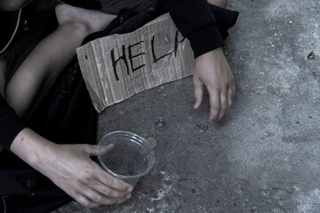 Beggar.Homeless boy or teenager begs for alms.Black and white 