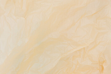 Close up of brown plastic bag, The plastic surface is wrinkly and tattered making abstract pattern.
