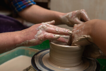Clay, ceramics or hands in a design workshop working on an artistic cup or mug. The hand of a creative artist or worker making crafts in sculpture