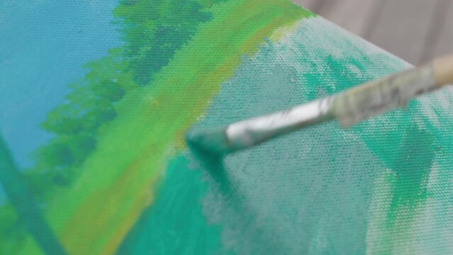 Paint Brush Strokes On Canvas With Green Acrylic Paint. closeup shot