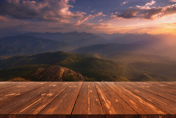 Beautiful sunrise over mountains and empty wooden table in nature outdoor. Natural template...