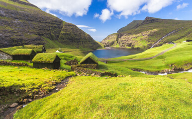 Nordic natural landscape, Saksun, Stremnoy island, Faroe Islands, Denmark. Iconic green roof houses.