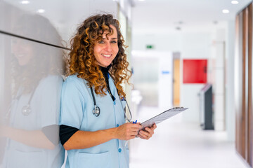 Happy nurse looking at camera while working in the hospital