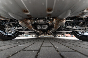 A closeup photo of sport car suspension and exhaust