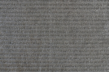 abstract background of grey furniture upholstery with ribbed trim texture close up
