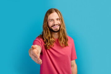 Portrait of satisfied cheerful person beaming smile raise arm you greeting handshake isolated on blue color background
