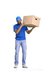 A male deliveryman, on a white background, in full height, shakes a box