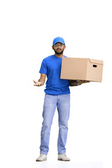 A male deliveryman, on a white background, in full height, with a box, throws up his hands