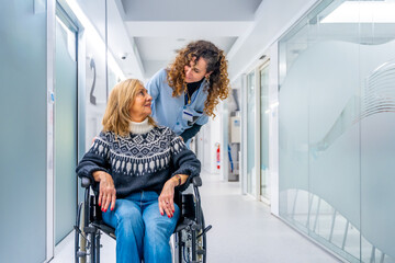 Nurse talking to a woman in wheelchair in the hospital