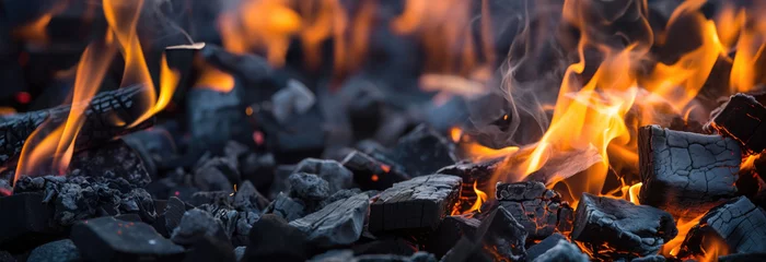 Poster Burning firewood and coals of a fire close up. Background for grilled food with fire. © petrrgoskov
