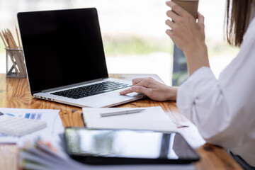 Young business hispanic woman work on laptop desk doing math finance on an office desk, tax, report, accounting, statistics, and analytical research concept