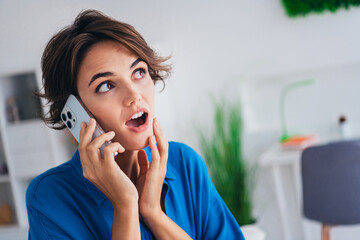 Portrait of impressed pretty person open mouth hand touch chin communicate telephone apartment...