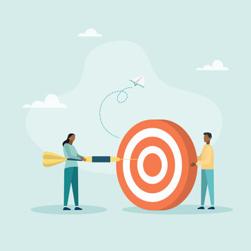 An employee tries to throw a dart at a large concentric dart board held by a leader, a concept for motivating employees to achieve goals.
