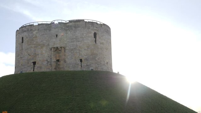 York Clifford tower with sun flare, slow motion.