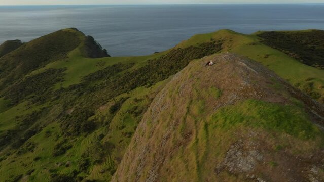 Aerial: Rocky headlands, beach and ocean waves of Spirits Bay, Northland, New Zealand.