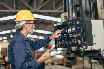 senior professional engineer working control operate program CNC milling machine in heavy industry factory - Powered by Adobe