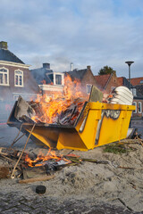 A burning yellow container with heavy smoke on New Year's Day in a village in the Netherlands	