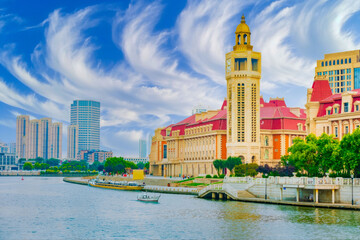 Vibrant Waterfront Cityscape with Classic and Modern Buildings, Golden Domed Tower, Blue Sky