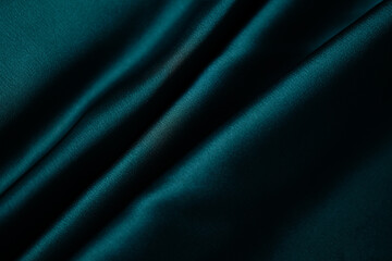 Emerald green silk or satin, draped fabric, elegant background.