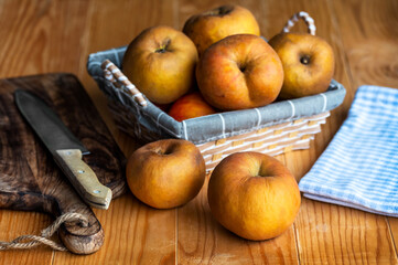 Organic apple known in Serbia as kozara in a wicker basket on an old wooden table