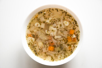 Vegetable, vegan and vegetarian soup in a plate on a white background. Healthy eating.
