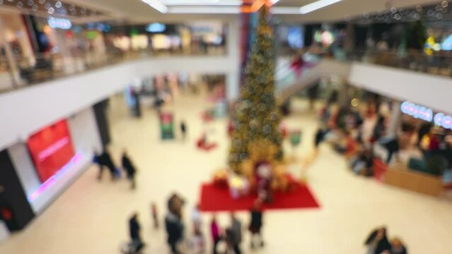 Santa Claus spreading festive magic in a Christmas defocused entertainment spectacle at a huge mall