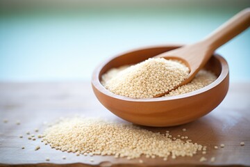 raw quinoa grains in wooden scoop