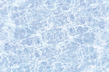 Obraz premium Bluewater waves on the surface ripples blurred. Defocus blurred transparent blue colored clear calm water surface texture with splash and bubbles. Water waves with shining pattern texture background.