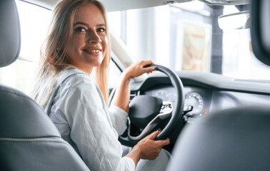 Modern quality interior. Woman is sitting in a car and driving it