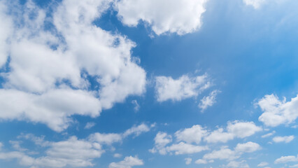 Panoramic view of clear blue sky and clouds, Blue sky background with tiny clouds. White fluffy clouds in the blue sky. Captivating stock photo featuring the mesmerizing beauty of the sky and clouds.
