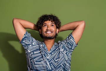 Photo of young cheerful hispanic man in stylish shirt take nap look up and dreaming about his holidays isolated on khaki color background