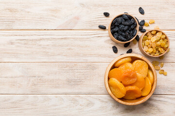 Bowl with different dried fruits on table background, top view. Healthy lifestyle with copy space