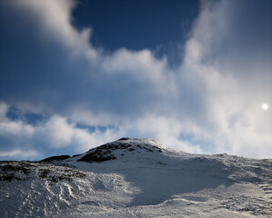 Fototapeta na wymiar Snow mountain under a cloudy sky.