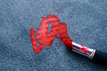 Dirty stain of lipstick on the carpet or sofa upholstery. daily life stain concept. top view 