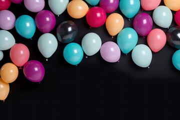 Colorful balloons on a black background with copy space for text, suitable for celebrations and parties.